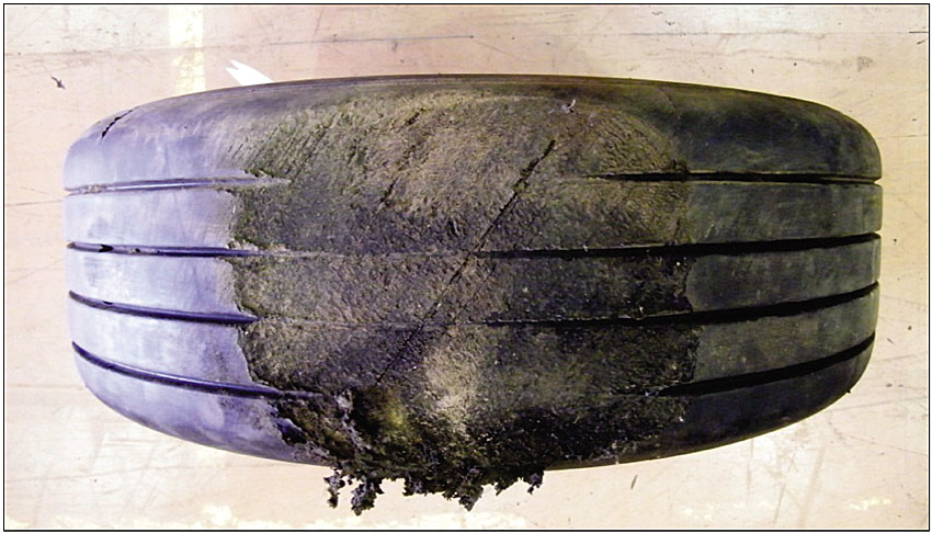 Photo of Damage seen on main landing gear tire no. 2 was evident on all 4 main landing gear tires.