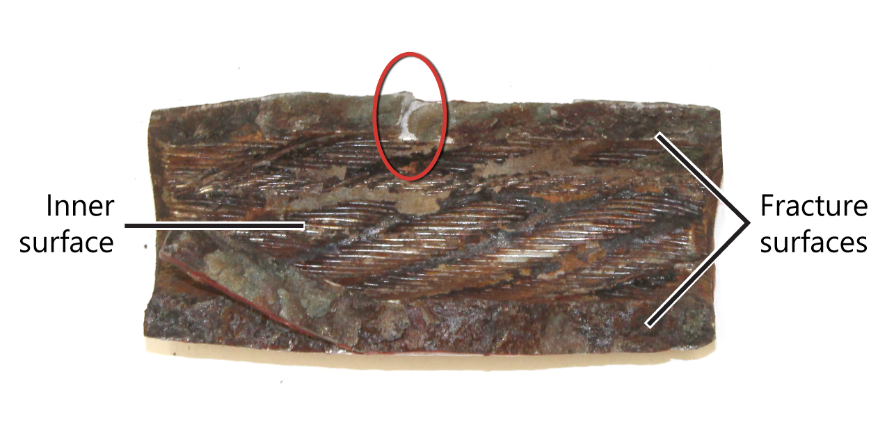 Inner surface and fracture surfaces of the broken aft starboard crimp sleeve, as well as a small region of fresh fracture (circled) (Source: TSB)